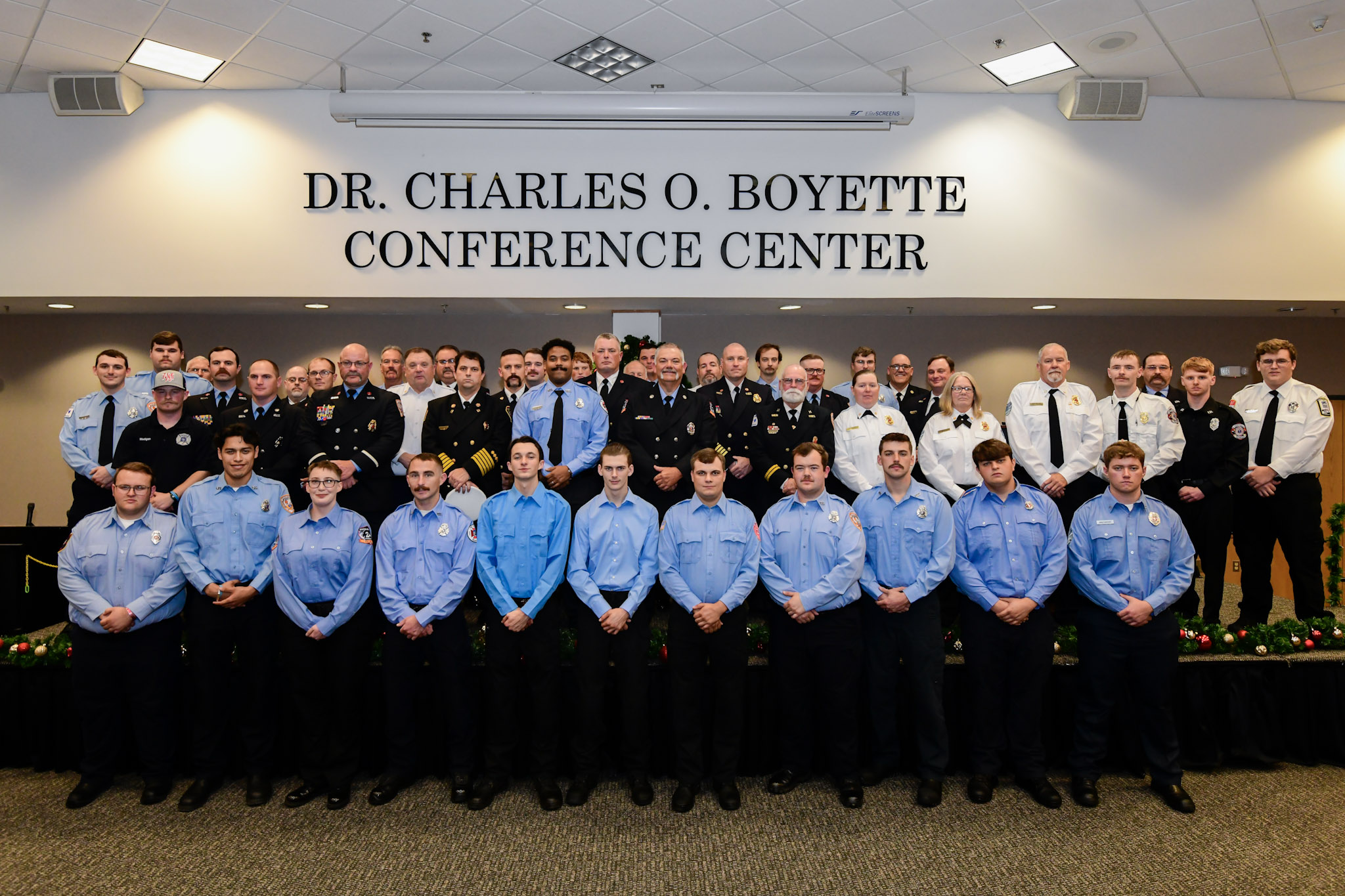 people in blue uniforms in front of a large group