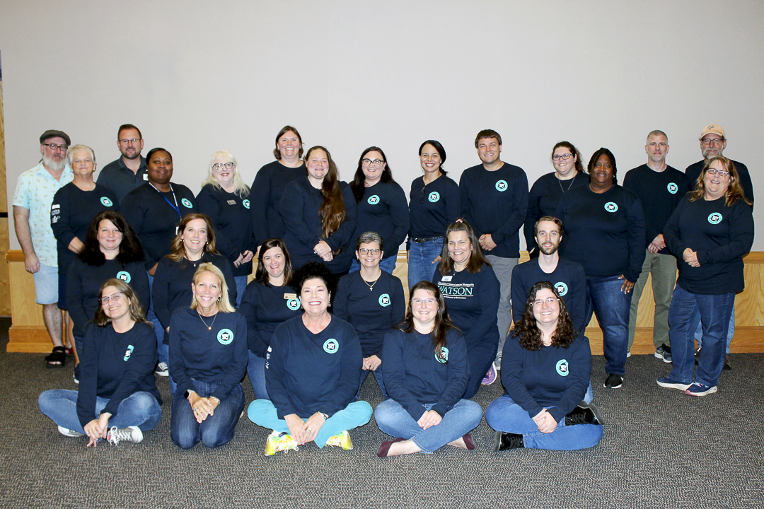 a large group in navy colored shirts