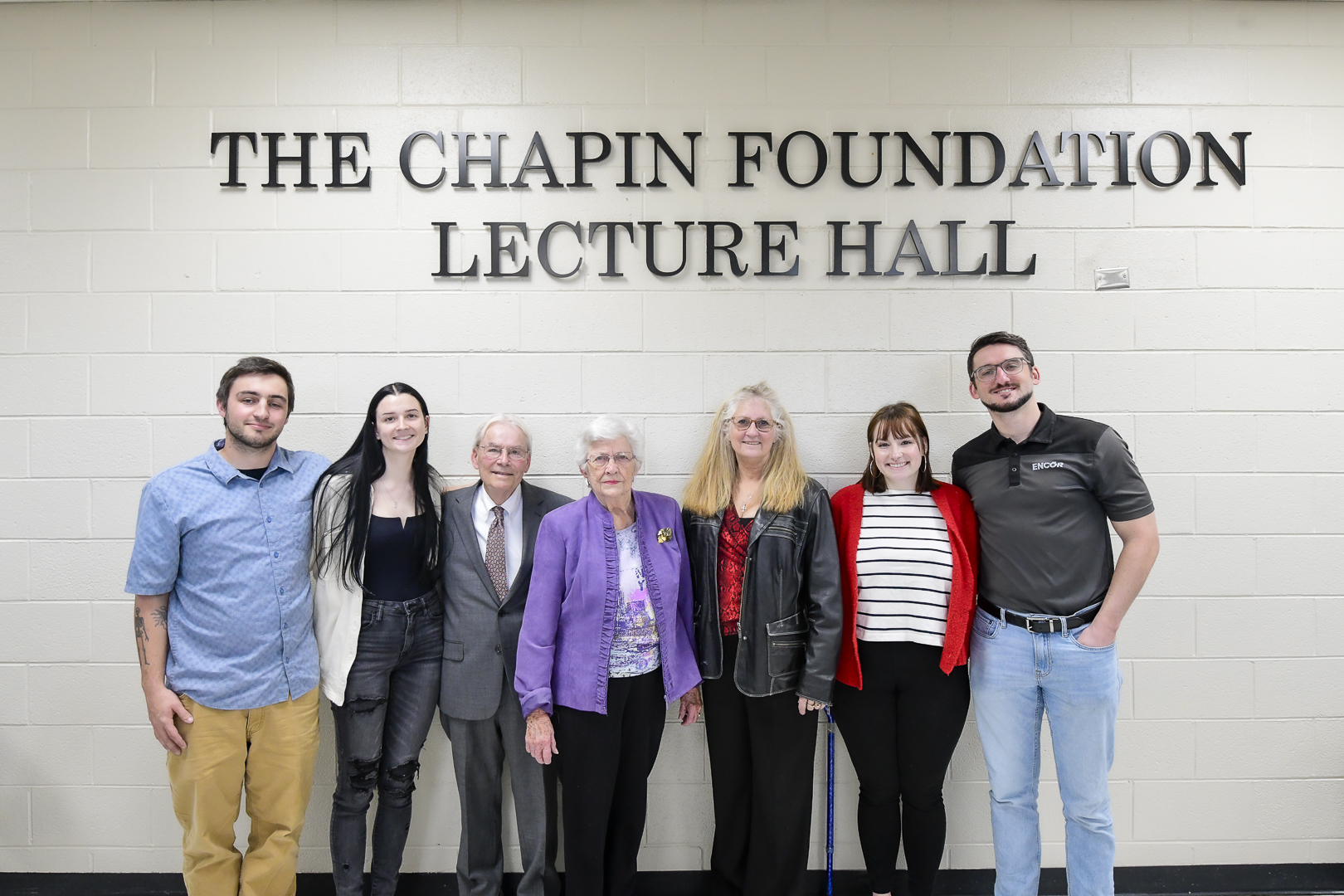 people under large letters reading The Chapin Foundation Lecture Hall