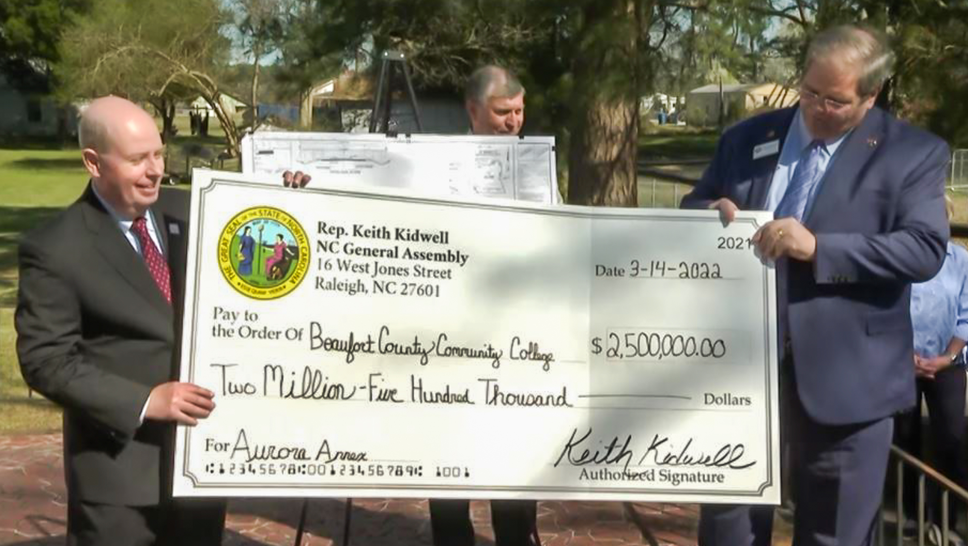 two people with a big check