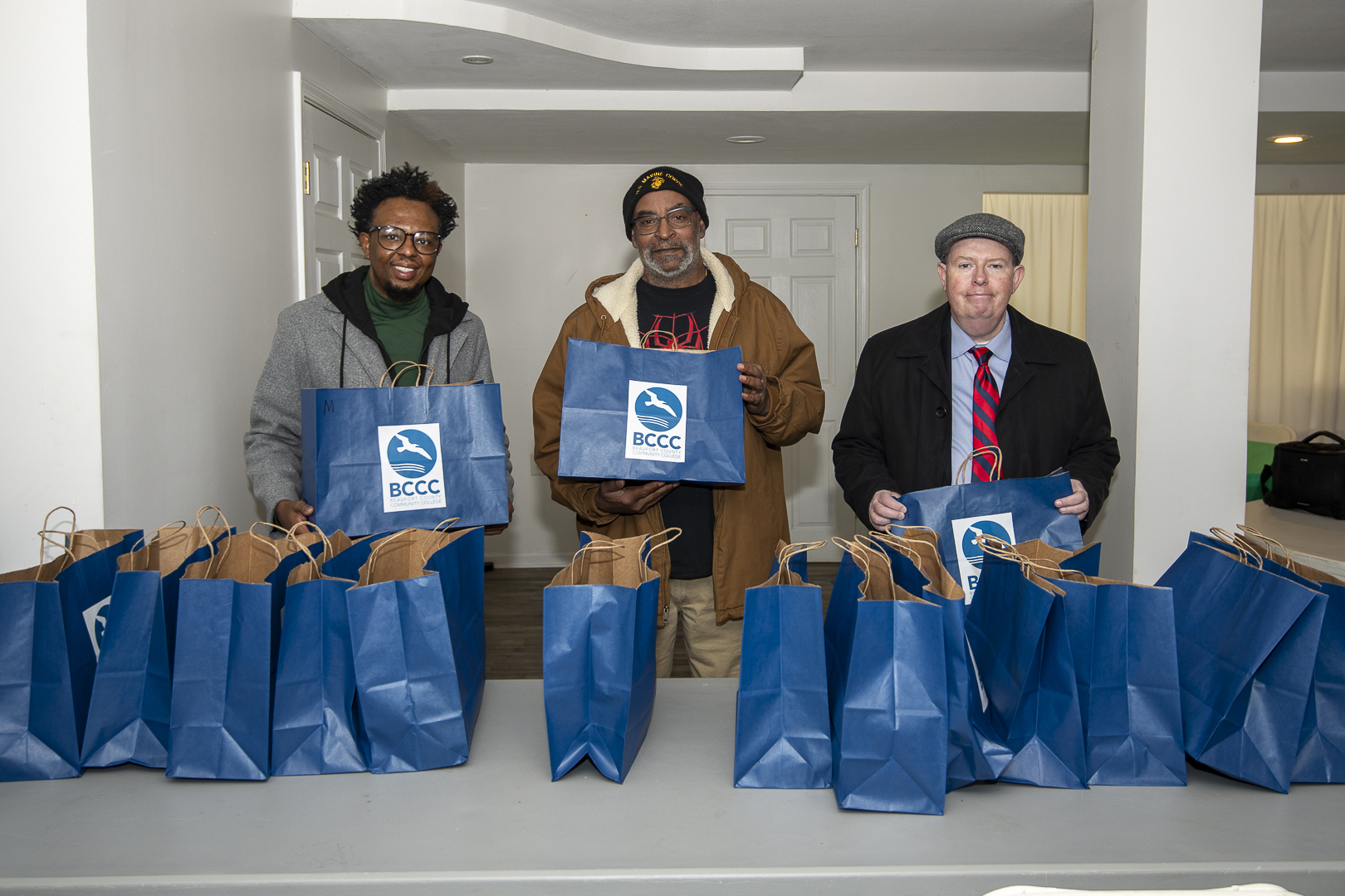 three people holding bags