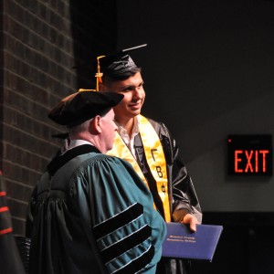 a person receiving a diploma